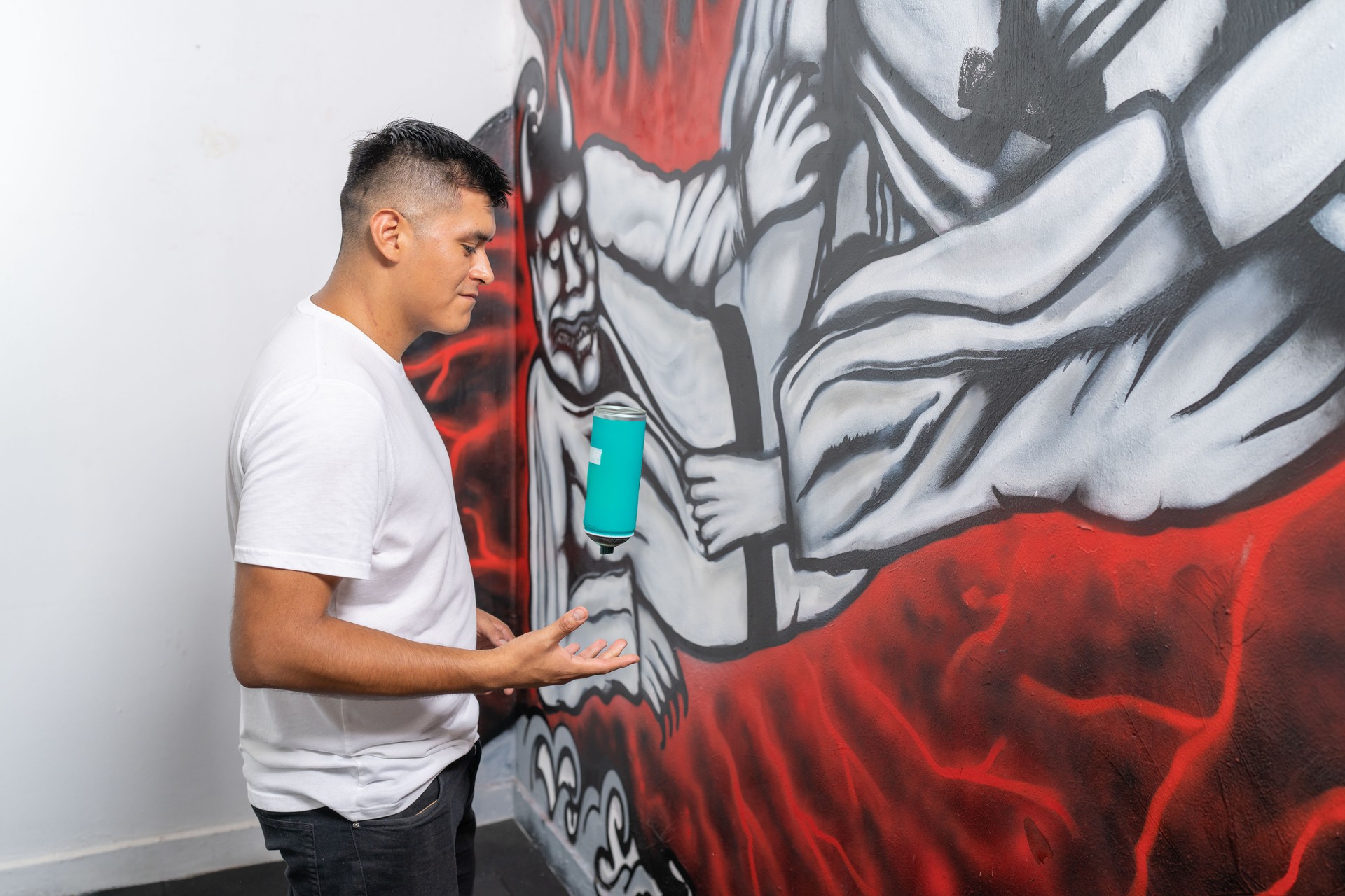 Muralist showing his graffiti art on wall